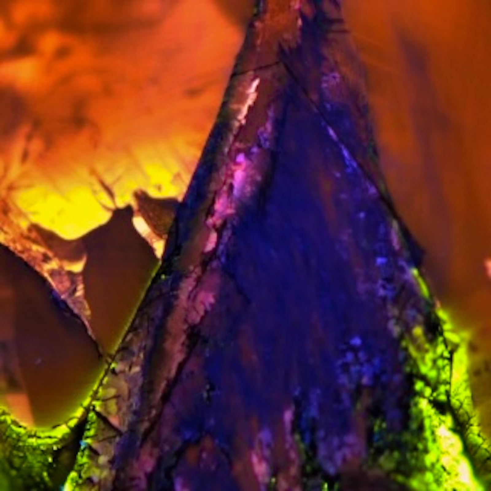 An extremely close-up image of a colorful mineral or rock.